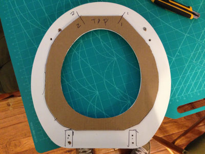 The seat was removed, a tracing of the seat inside made on the cardboard and the frame cut out.